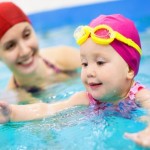 Mother teach baby swimming