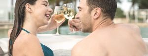 happy couple relax and drink at hot tub