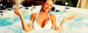 woman soaking in the best outdoor hot tubs